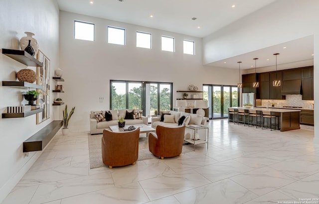 living area with marble finish floor, recessed lighting, and baseboards