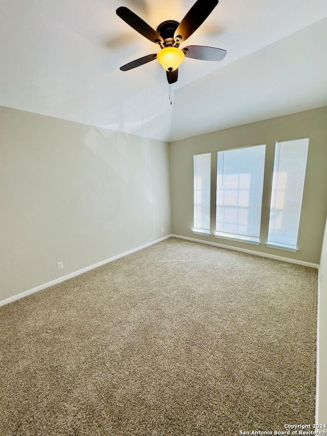 spare room with vaulted ceiling, ceiling fan, and carpet floors