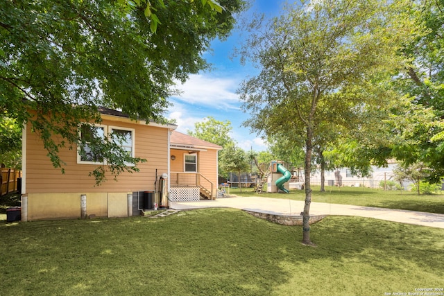 exterior space with a playground and central air condition unit