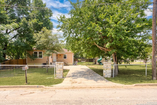 view of front of house featuring a playground and a front yard