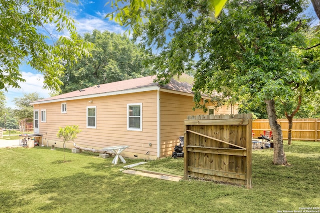 rear view of property featuring a yard