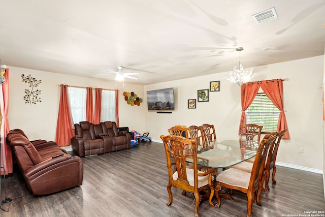 dining room with dark hardwood / wood-style floors and ceiling fan with notable chandelier