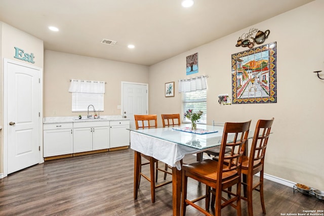 dining area with sink and dark hardwood / wood-style floors