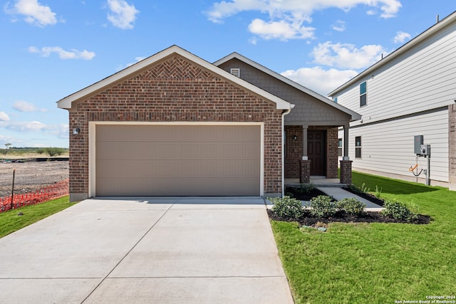 view of front of property with a garage and a front lawn