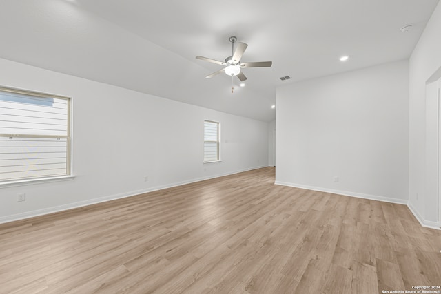 spare room with ceiling fan, light hardwood / wood-style floors, and lofted ceiling