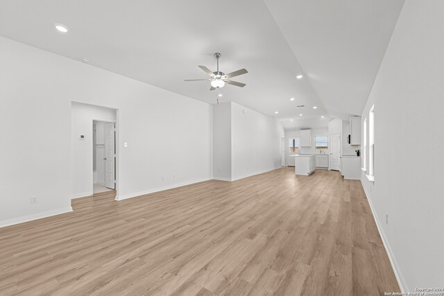 unfurnished living room with ceiling fan and light hardwood / wood-style floors