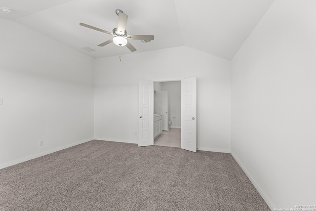 carpeted empty room featuring ceiling fan and lofted ceiling