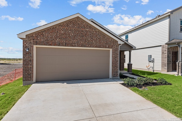 view of front facade featuring a front yard and a garage