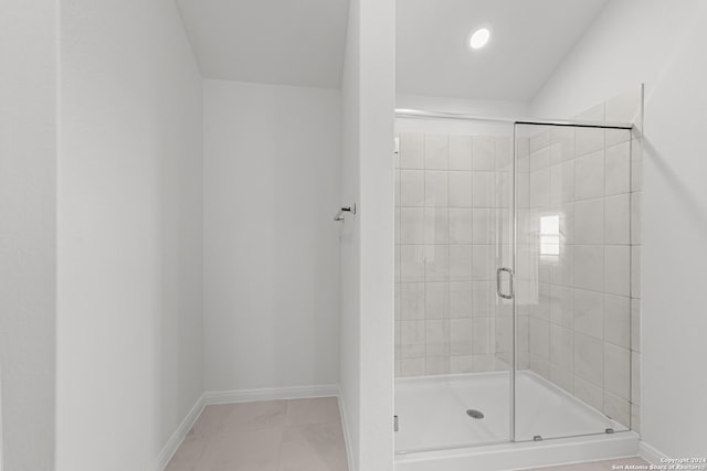 bathroom featuring tile patterned floors and a shower with door