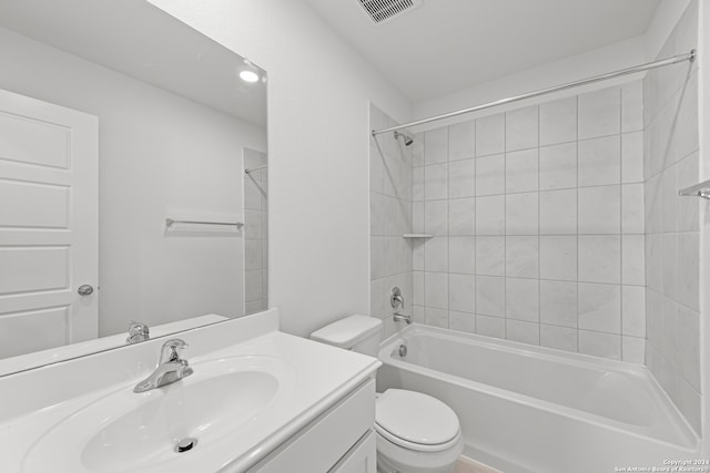 full bathroom with toilet, vanity, and tiled shower / bath