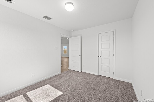 unfurnished bedroom with carpet flooring