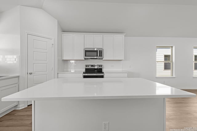 kitchen with white cabinets, a center island, and stainless steel appliances