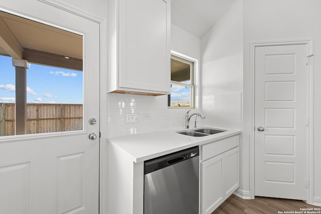 kitchen with white cabinetry, dishwasher, sink, dark wood-type flooring, and backsplash