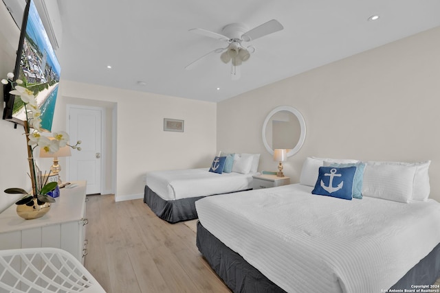 bedroom with ceiling fan and light hardwood / wood-style floors