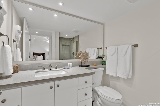 bathroom with vanity, toilet, and a shower with shower door