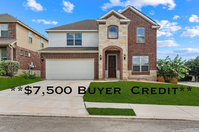 view of property with a front yard and a garage