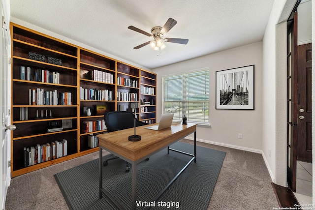 carpeted home office featuring ceiling fan and a textured ceiling