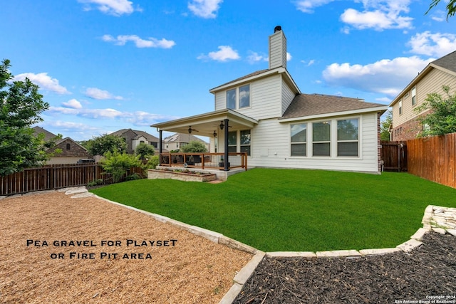 rear view of property featuring a lawn, a patio area, and ceiling fan