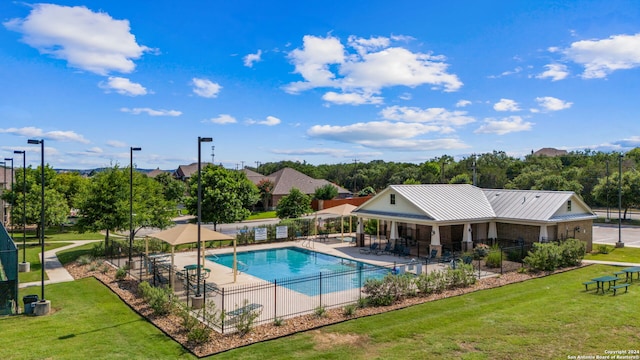 view of swimming pool with a lawn and a patio area