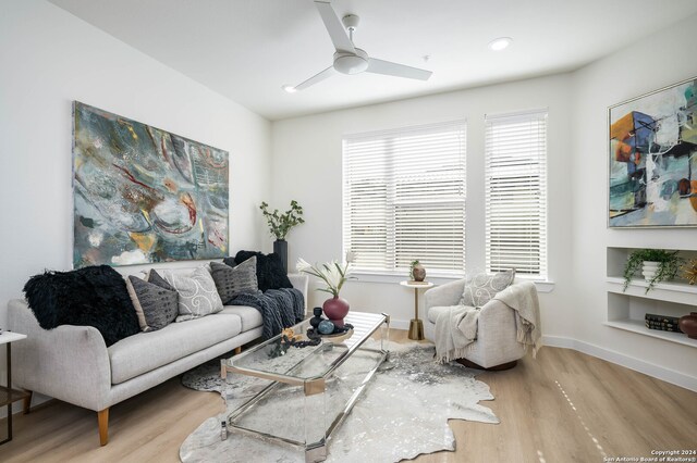 living room featuring ceiling fan and hardwood / wood-style flooring