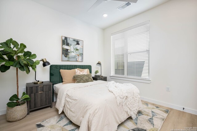 bedroom featuring light hardwood / wood-style floors and ceiling fan