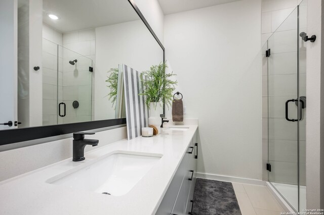 bathroom with tile patterned flooring, vanity, and an enclosed shower