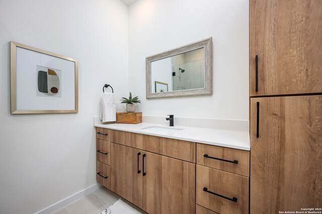 bathroom featuring tile patterned flooring and vanity