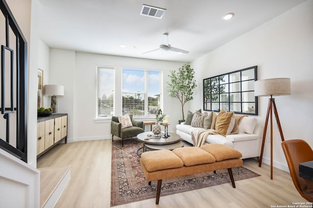 living room with ceiling fan, plenty of natural light, and light wood-type flooring