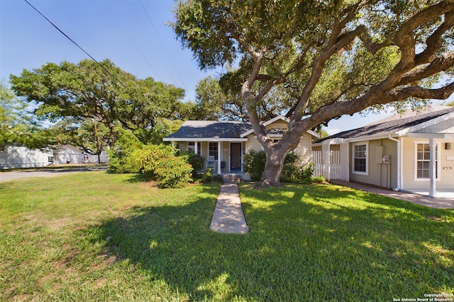 view of front of home with a front yard, a porch, and stucco siding