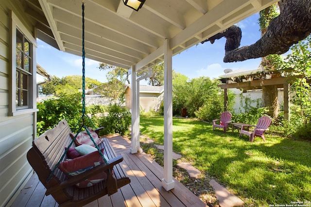 wooden deck featuring a lawn