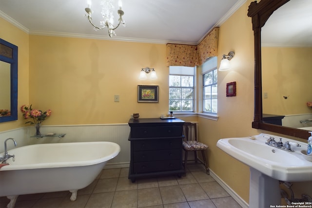full bath featuring a wainscoted wall, a soaking tub, ornamental molding, tile patterned floors, and a notable chandelier
