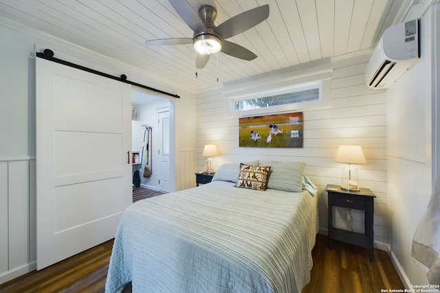 bedroom featuring dark wood finished floors, a wall unit AC, a barn door, wooden ceiling, and crown molding