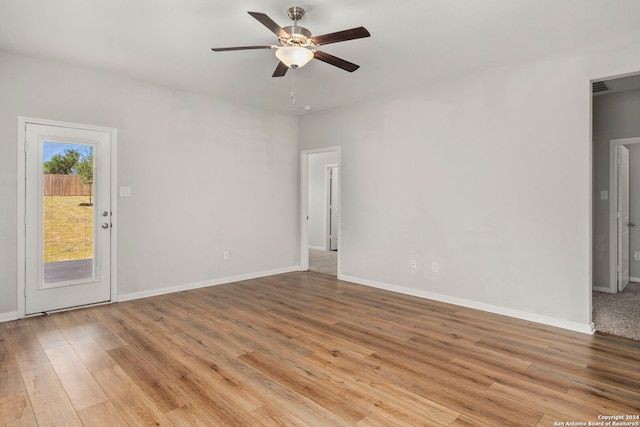 empty room featuring ceiling fan and light hardwood / wood-style flooring