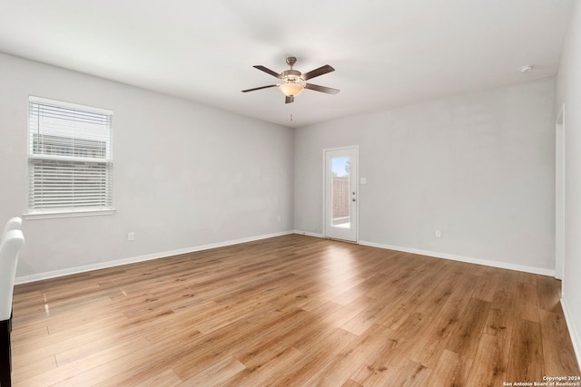 spare room with light hardwood / wood-style flooring, plenty of natural light, and ceiling fan