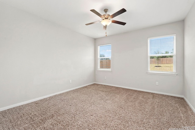 carpeted empty room featuring ceiling fan