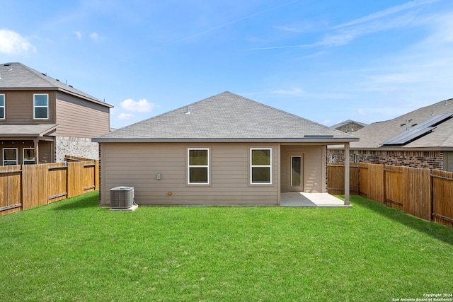 back of house with a patio area, a yard, and cooling unit