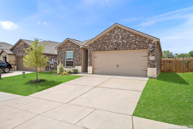 view of front of home with a garage and a front yard