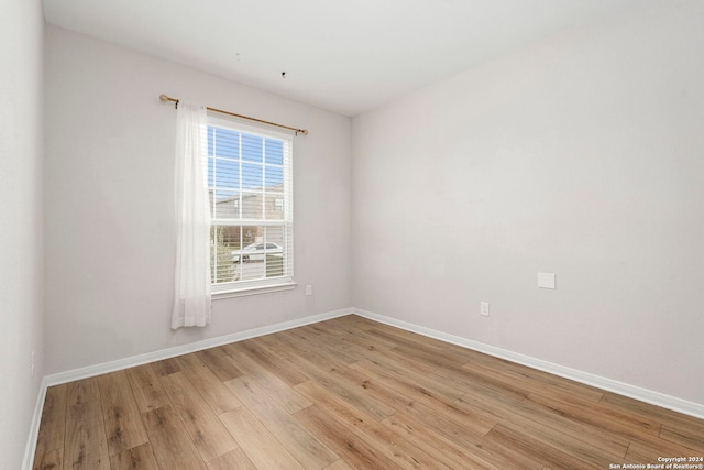 unfurnished room with light hardwood / wood-style floors