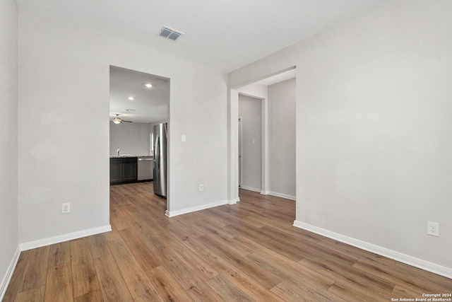 spare room featuring ceiling fan and light hardwood / wood-style floors