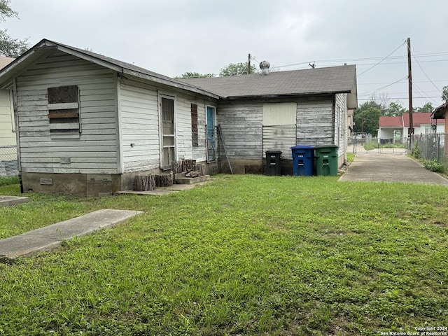 rear view of property with a lawn