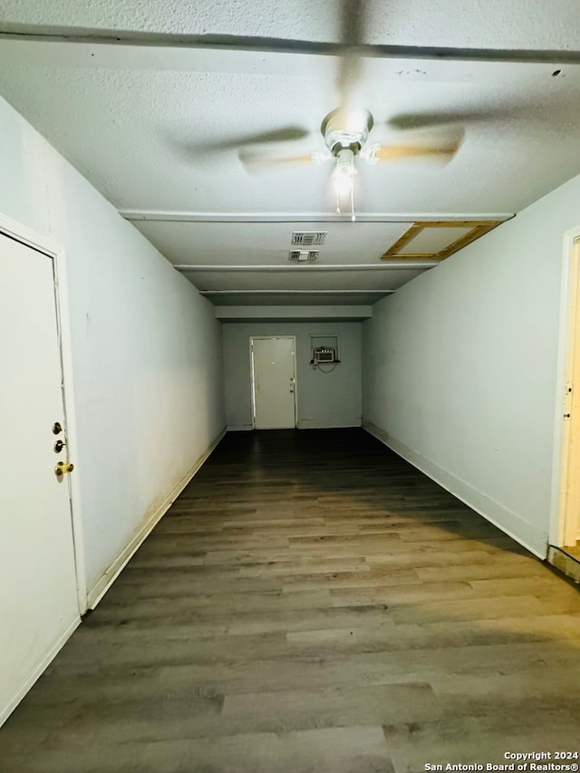 spare room with hardwood / wood-style flooring, ceiling fan, and a textured ceiling