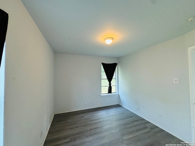 empty room with dark wood-type flooring