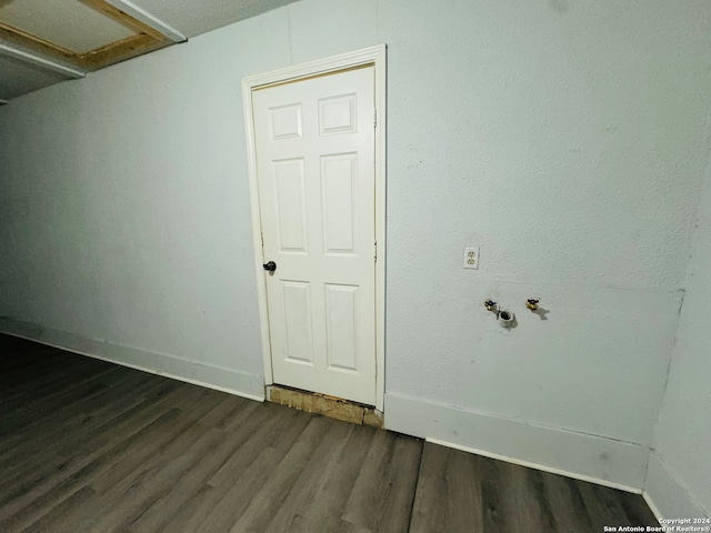 empty room with dark hardwood / wood-style flooring