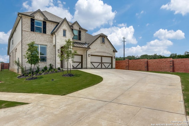 view of front of property featuring a garage and a front yard