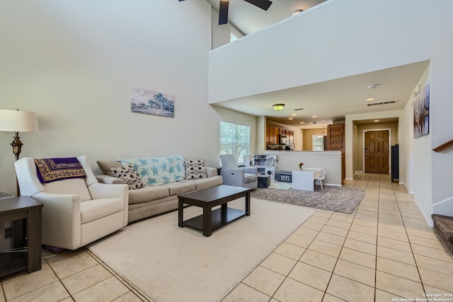 living room with ceiling fan and light tile patterned floors