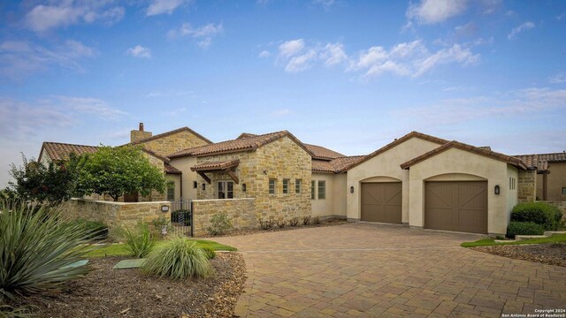 mediterranean / spanish-style house with a garage