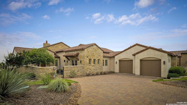 mediterranean / spanish house with a garage