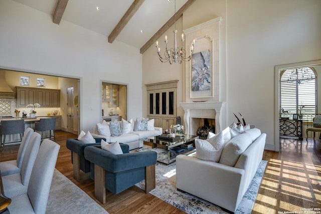 living room featuring dark wood-type flooring, a high end fireplace, and high vaulted ceiling