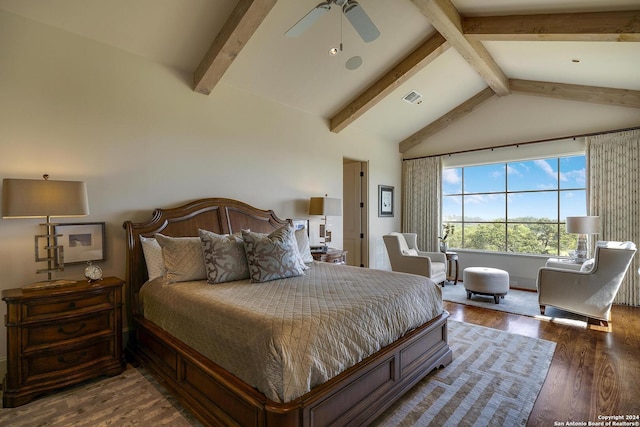 bedroom featuring ceiling fan, dark hardwood / wood-style floors, and vaulted ceiling with beams