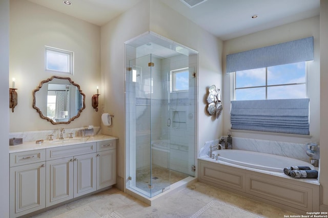 bathroom featuring vanity, shower with separate bathtub, and tile patterned flooring